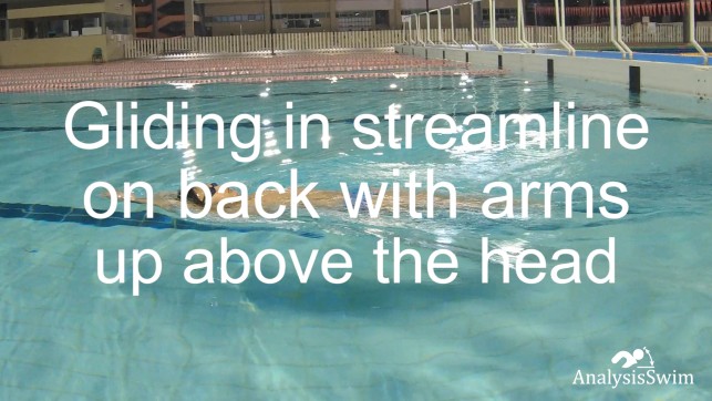 Gliding in streamline on back with arms up above the head